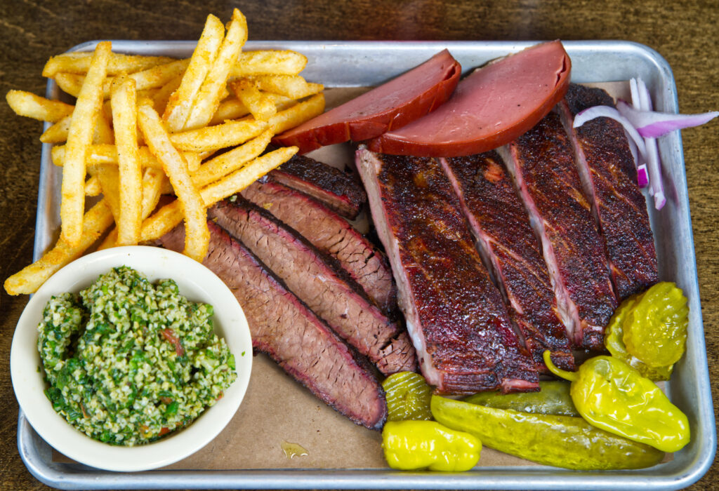 Three meat dinner with two sides.